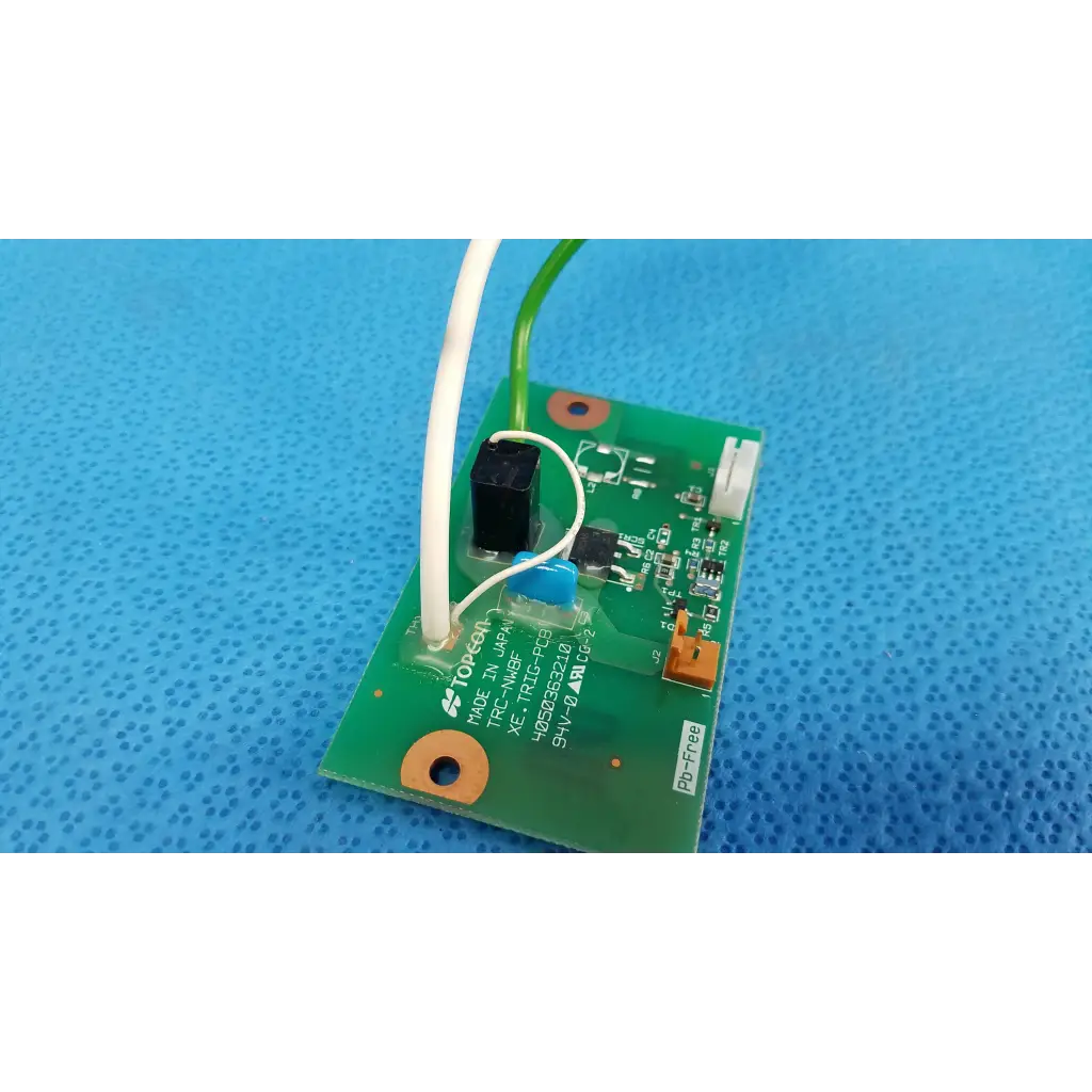 Green printed circuit board with black and blue components and white and green wires for internal xenon flash trigger pcb board