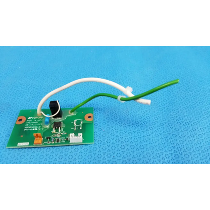 Green printed circuit board with white and green wires and black switch for xenon flash trigger in topcon fundus camera