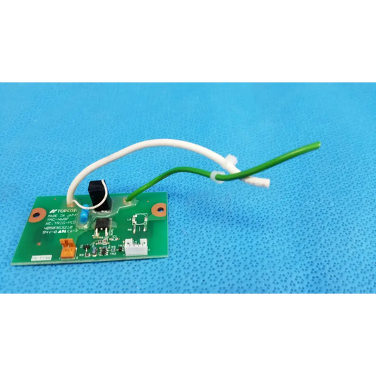 Green printed circuit board with white and green wires and black switch for xenon flash trigger in topcon fundus camera