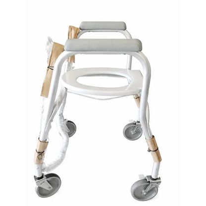 White metal-framed mobile shower commode chair with gray padded seat and four swivel wheels for easy mobility