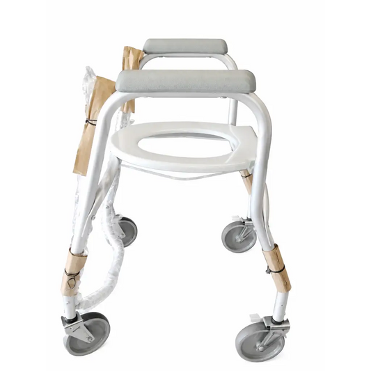 White metal-framed mobile shower commode chair with gray padded seat and four swivel wheels for easy mobility