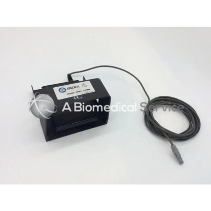 Black rectangular iridex 12167 ipx8 laser foot switch footpedal with white spherical component and coiled gray cable