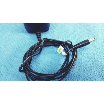 Black coiled power adapter cable with metallic connector and white tag for jameco reliapro transformer input vac model dc060120