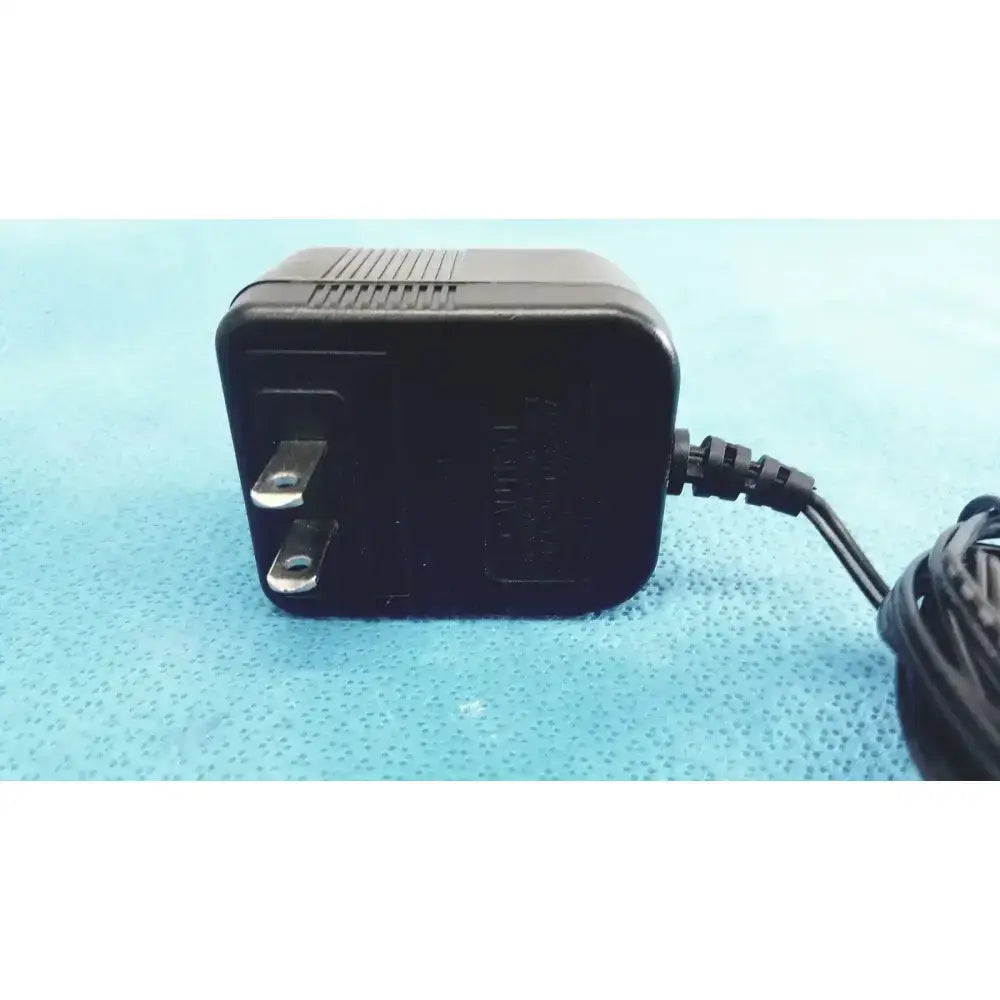 Black plastic jameco reliapro ac adapter with two-prong plug and coiled power cord transformer input vac model