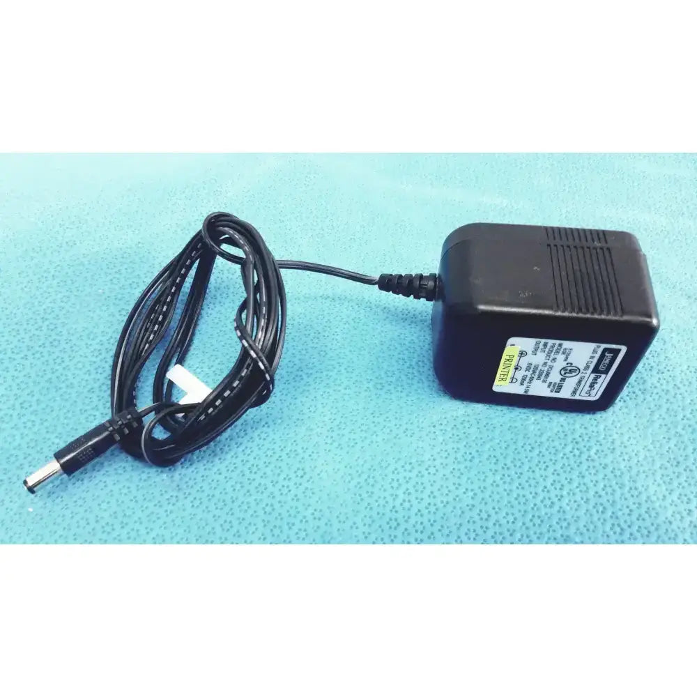Black plastic jameco reliapro plug-in class 2 transformer input with coiled cable and cylindrical connector vac model dc060120