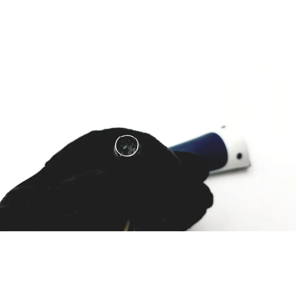 A black-gloved hand holds a chrome socket wrench with blue and white handle for jadak barcode scanner use