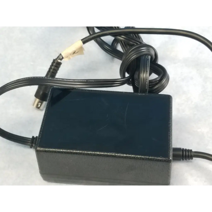 Black plastic Jerome Industries ILTK-51 power supply adapter with coiled cable and metallic connector for 120V 60Hz use