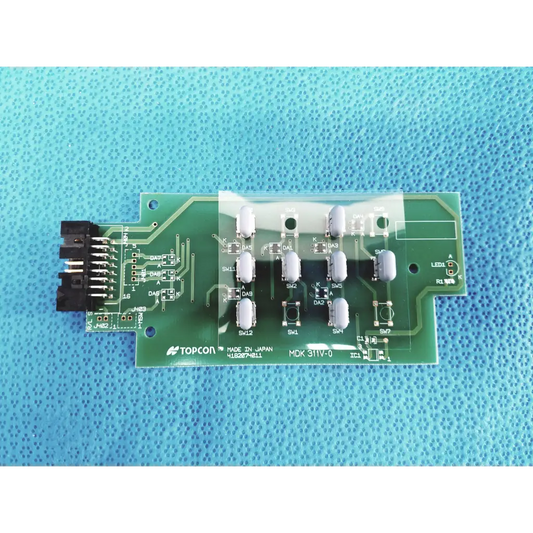 Green pcb board with white cylindrical components and black connector labeled topcon mdk 31iv-0 for fundus retinal camera