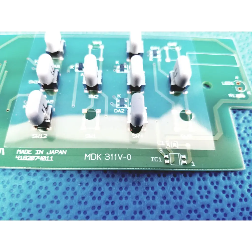 Green pcb board with white cylindrical components labeled made in japan mdk 311v-0 for fundus retinal camera