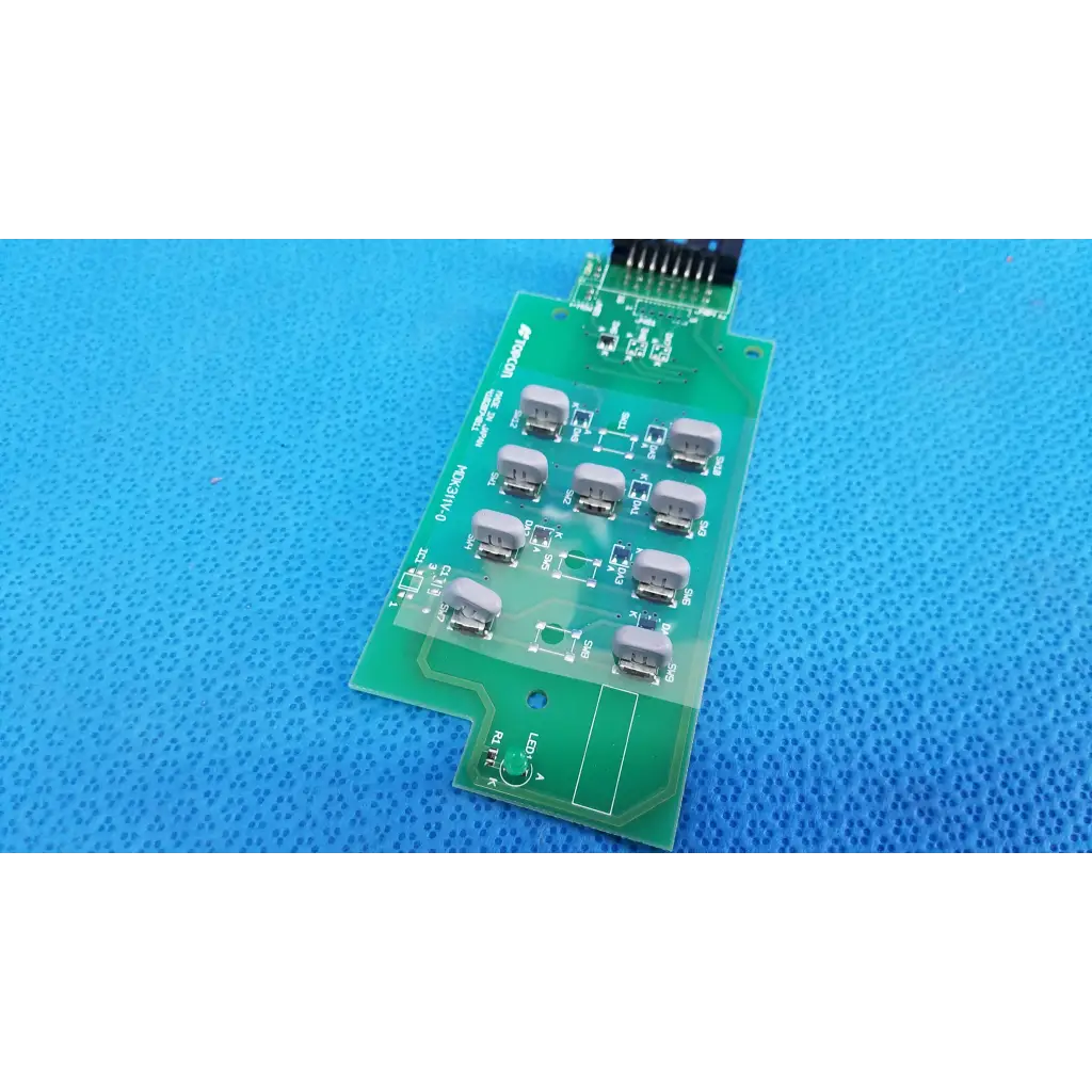 Green printed circuit board with gray components and black connector for joystick base control button matrix pcb