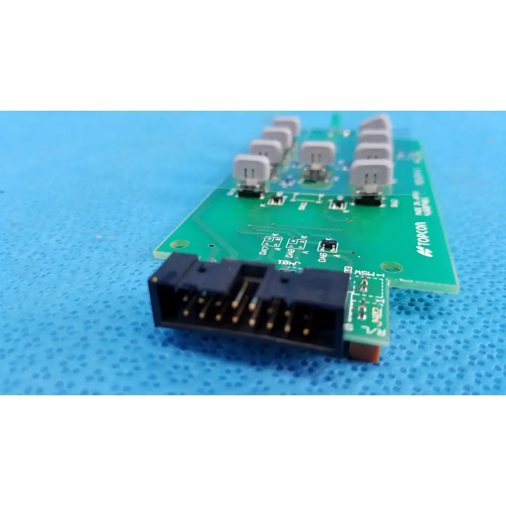 Green joystick base control button matrix pcb with black connector and gray capacitors for topcon retinal camera