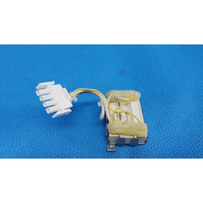 White plastic connector with yellow wiring attached to metallic resistor block assembly for topcon retinal camera