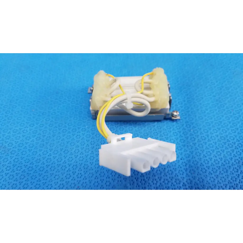 Yellow and white insulated wire connected to beige plastic resistor block assembly for topcon trc-nw6s retinal camera
