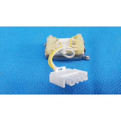 Yellow and white insulated wire connected to beige plastic resistor block assembly for topcon trc-nw6s retinal camera