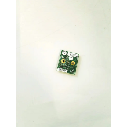 Green rectangular k750545-02 circuit board with two gold circular connectors and white labeling stickers