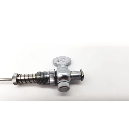 Silver-colored metal surgical valve engraved storz w on the karl storz 26120j optical bridge 26120j optical bridge