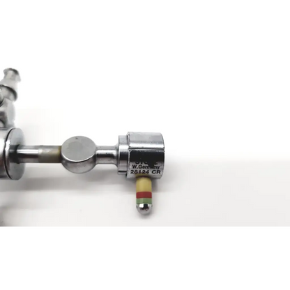 Silver metallic karl storz 28124cr cannula with yellow red striped tip and dual rotating stopcocks for surgical use