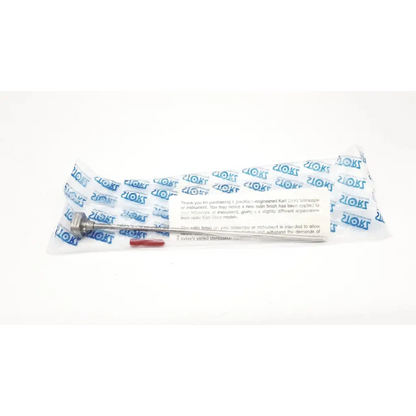 Metallic slender karl storz 28128rs sharp obturator with textured handle and fine tip in clear plastic packaging with blue branding