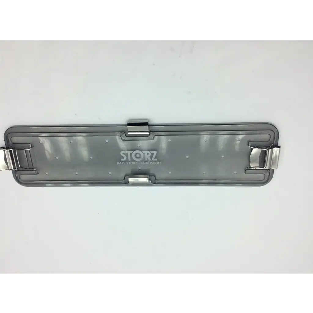 Back side of gray translucent plastic karl storz flexible scope sterilization tray with silver metal clasp and storz logo
