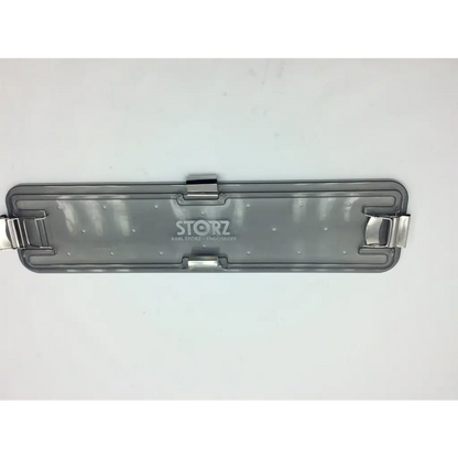 Back side of gray translucent plastic karl storz flexible scope sterilization tray with silver metal clasp and storz logo