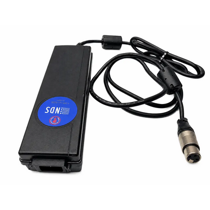 Black rectangular karl storz tc009 cable adapter with blue sdn label connected to coiled cable and silver xlr connector