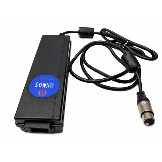Black rectangular karl storz tc009 cable adapter with blue sdn label connected to coiled cable and silver xlr connector