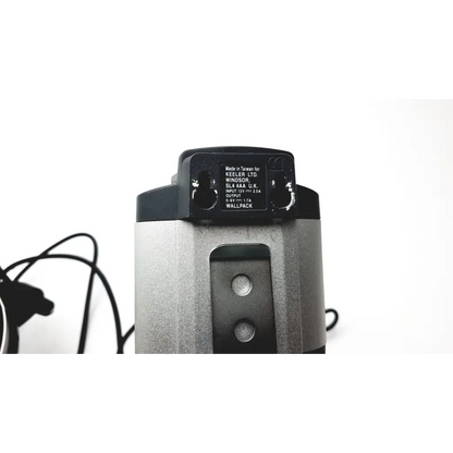 Silver and black cylindrical wall pack with matte finish and made in taiwan label for keeler vantage plus led bio ophthalmoscope