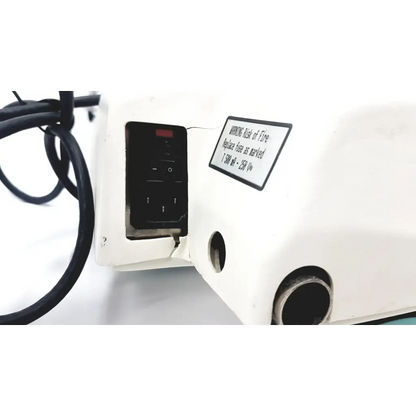 White industrial sewing machine kinetec optima ability with black control panel and warning label for heavy-duty use