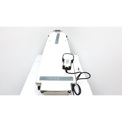 White industrial conveyor belt with black control unit and power cord of kinetec optima ability one motion machine