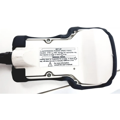 White and black kinetec optima ability handheld device showing setup instructions for extension, flexion, and speed controls