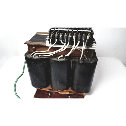 Black cylindrical power transformer by Kowa Sangyo with copper windings and white insulated wires for reuse medical applications