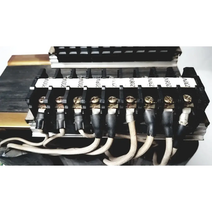 Black electrical terminal block with gold screws and labeled insulators for 208v connected to kowa sangyo power transformers