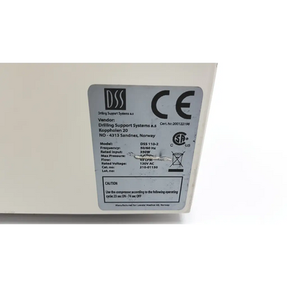 White plastic label with black text showing laerdal dss air compressor af5-65 technical specs on back of product