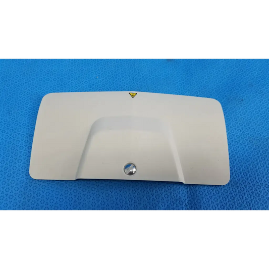 White plastic lamp house cover panel for trc-nw6s retinal camera with central metallic screw and yellow warning triangle