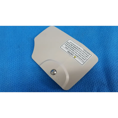Beige plastic lamp house cover panel with silver screw and warning label for Topcon TRC-NW8 retinal camera lamp house