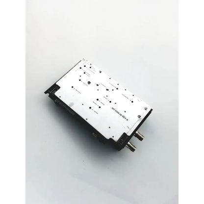 Black and white rectangular lark eng fx700-081 electronic module with metallic connectors on one side