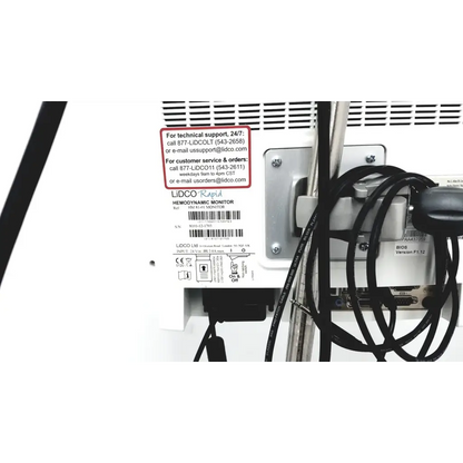White plastic lidco hm-81-01 rapid hemodynamic monitor with power supply black cables and silver metal bracket