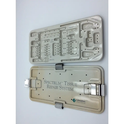 Beige plastic linvatec spectrum tissue repair system case with silver metal clasps and embossed logo text