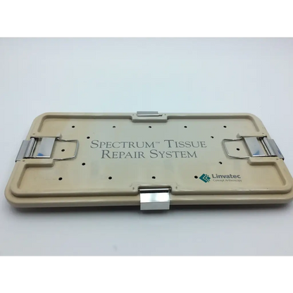 Beige plastic linvatec spectrum tissue repair system case with silver metal latches and engraved branding