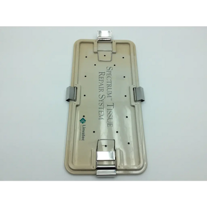 Beige plastic linvatec spectrum tissue repair system case with silver metal clasps and hinges for secure storage