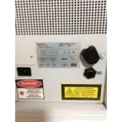 White industrial laser engraving machine with black connectors and warning labels lumenis lightsheer 5390 laser ipl