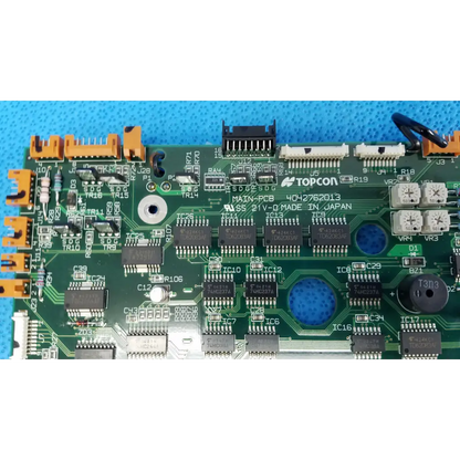 Green motherboard circuit board with black integrated circuits and orange connectors for topcon retinal camera