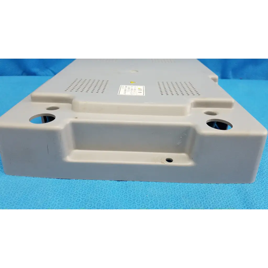Beige plastic main unit bottom cover panel with ventilation and mounting holes for Topcon TRC-NW8 retinal camera back side