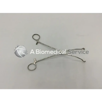 Stainless steel marina medical mccall clamp 350-252 with curved pointed tips and circular finger loops for surgery