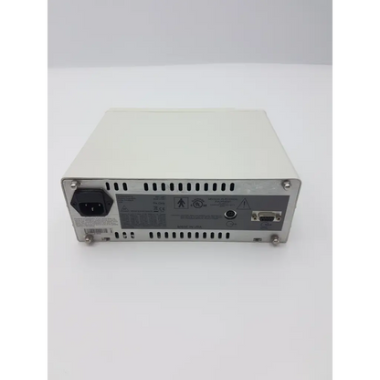 Beige metal power supply unit with black ac input plug and certification labels on the back of masimo 1603 signal extraction pulse oximeter rad 9