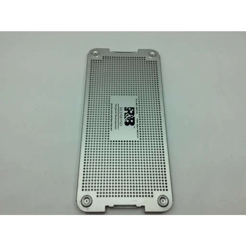 Silver perforated metal plate with central logo and four corner screws for mcculloch retractor instrument tray
