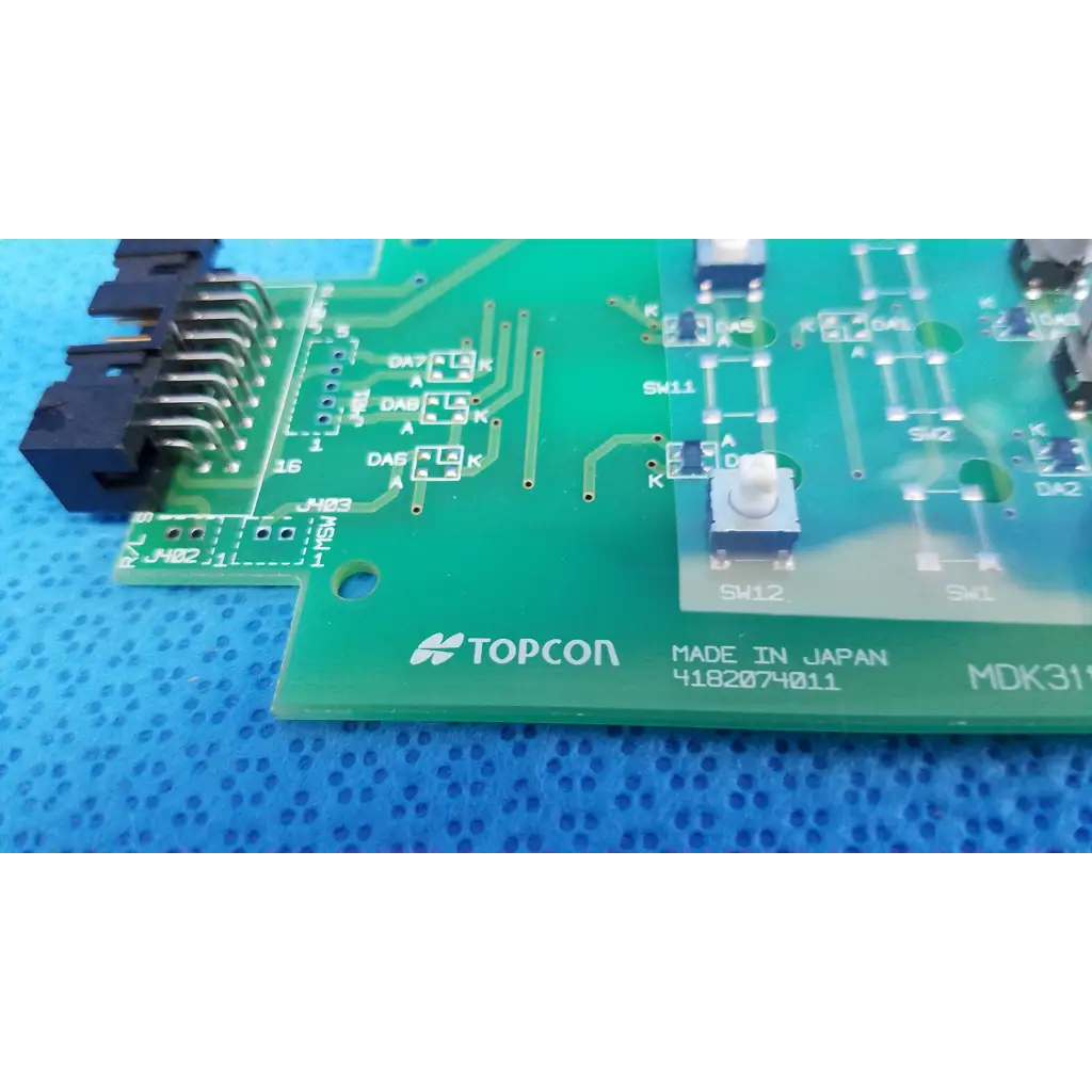 Green topcon control panel button switch circuit board with printed labels and black connector for retinal camera