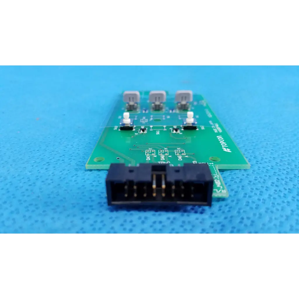 Green printed circuit board control panel button switch with three gray components and black connector for topcon camera