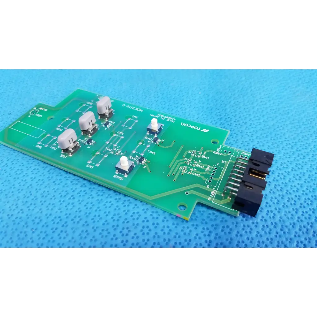 Green control panel button switch circuit board with beige and black switches labeled topcon for retinal camera use