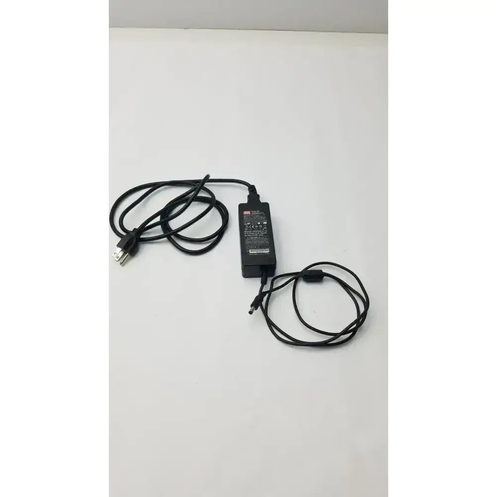 Black plastic mean well gs60a24-p1j power supply adapter with coiled black cables and standard plug for electronic devices